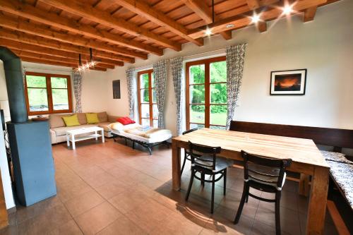 a living room with a wooden table and chairs at Apartmány Maršíkov in Velké Losiny