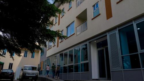 a group of people standing outside of a building at Monarch Hotel in Accra