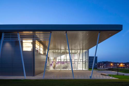 a large building with a glass facade at night at Warwick Conferences - Radcliffe in Coventry
