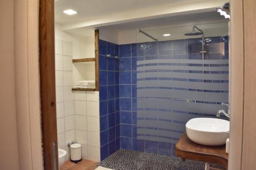 a bathroom with a blue tiled shower with a sink at Raito Home costa d'Amalfi in Vietri sul Mare