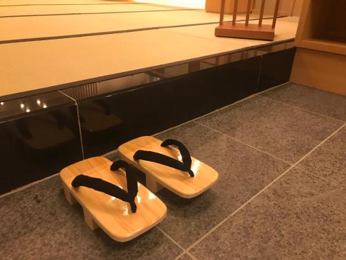 a pair of sandals sitting on the floor in a gym at Onyado Nono Asakusa Natural Hot Spring in Tokyo
