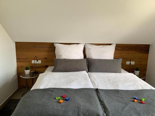 a bedroom with a bed with some toys on it at Appartementanlage Lancken-Granitz in Lancken-Granitz