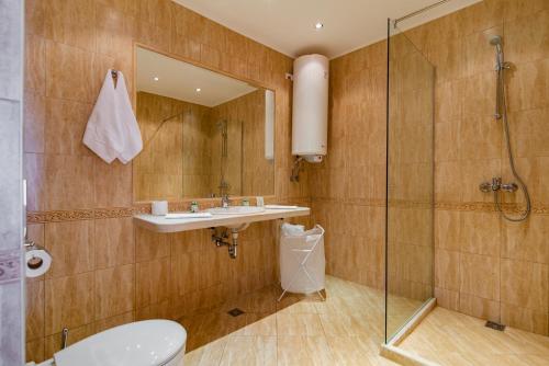 a bathroom with a sink and a shower at Varna South Bay Beach Residence in Varna City