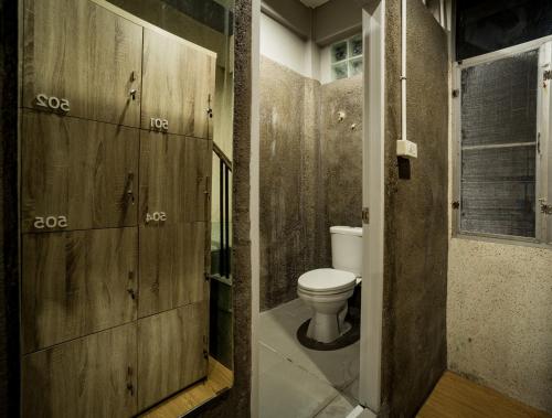 a bathroom with a toilet and a sink at Mind Day Hostel Khaosan in Bangkok