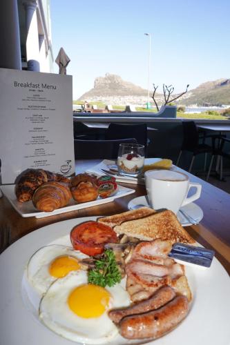 a table topped with plates of food at Chapmans Peak Beach Hotel in Hout Bay