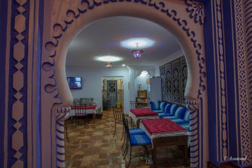 an archway with chairs and tables in a room at Puerta Azul in Chefchaouene