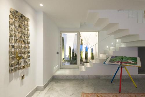 a hallway with a staircase in a house at Maison Dedine- SmallLuxuryHotels -Adults Only in Sidi Bou Saïd
