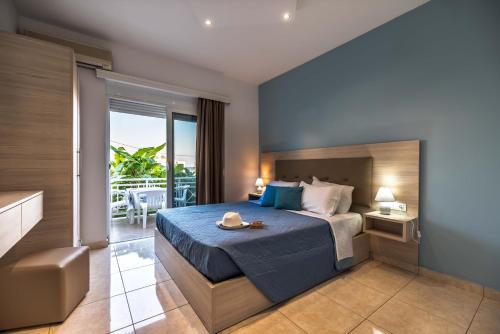 a bedroom with a bed and a balcony at Stegna Bay Apartment in Archangelos