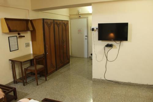 a room with a flat screen tv on the wall at YWCA International Centre in Mumbai
