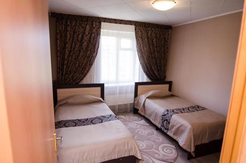 Postel nebo postele na pokoji v ubytování Uralochka Hotel