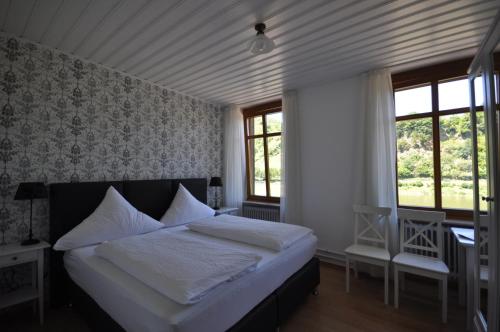En eller flere senger på et rom på Gästezimmer im Weingut Amlinger&Sohn