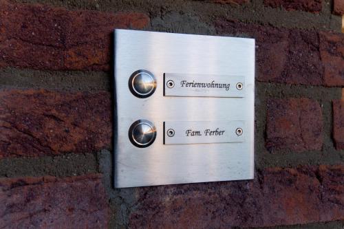 a metal sign on the side of a brick wall at FeWo Ferber in Andernach