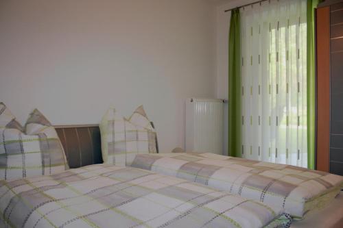 a bedroom with two beds and a window at Ferienwohnung Maria in Nittenau