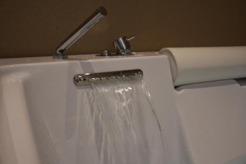 a white toilet with water coming out of it at Hotel Commercio in Battipaglia