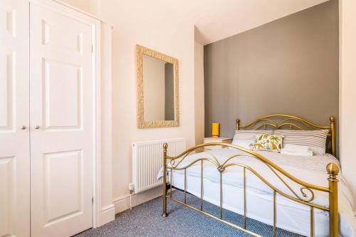 a bedroom with a bed and a mirror at PLATFORM Port Area Apartment 1 in Hull