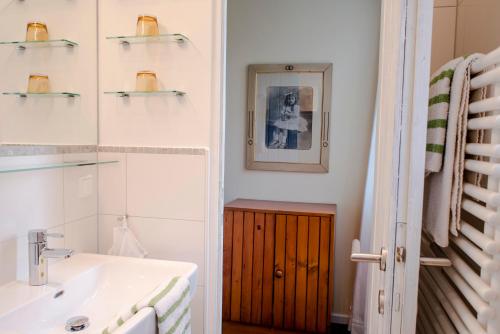 a bathroom with a sink and a mirror at Landhaus Hindenburg in Bad Gleichenberg