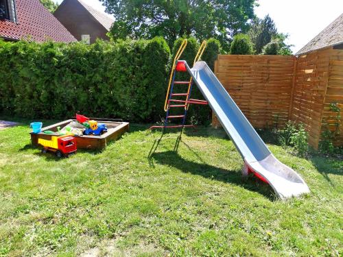 a playground with a slide and a play equipment at Ferienhaus mit 3 Schlafraeumen Vor in Woldegk