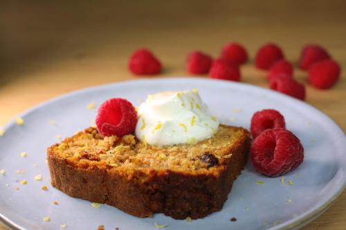 a piece of cake with whipped cream and raspberries on a plate at ibis Paris Bercy Village in Paris