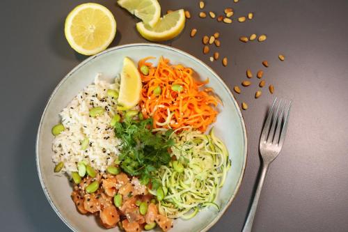 a plate of food with rice and vegetables and a fork at ibis Paris Bercy Village in Paris