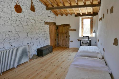 a room with three beds and a brick wall at La Casa de Salce in Salce