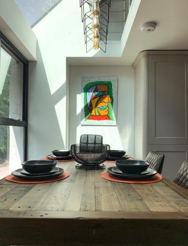 a dining room table with chairs and a stained glass window at Balloan Cottage Cowshed in Inverness