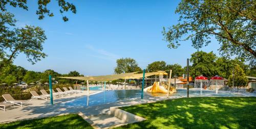 a swimming pool with a slide and a playground at Aminess Maravea Camping Resort Mobile Homes in Novigrad Istria