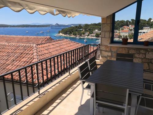 a balcony with a table and a view of the water at Penthouse in old Dalmatian house - Flybridge in Hvar