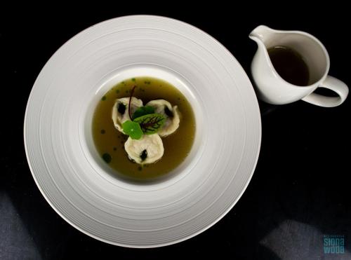 a plate with a bowl of soup and a cup of coffee at Hotel Testa in Sopot