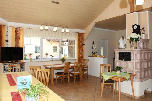 a kitchen and living room with a table and chairs at Appartementhaus Putz in Pocking