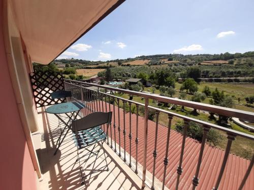 a balcony with a table and chairs and a view at Agriturismo Petrilli in Flumeri