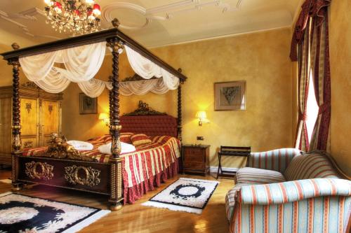 a bedroom with a canopy bed and a couch at Alchymist Grand Hotel and Spa - Preferred Hotels & Resorts in Prague