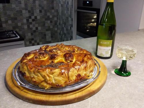 a cake on a table next to a bottle of wine at Bim Cathele in Burbach