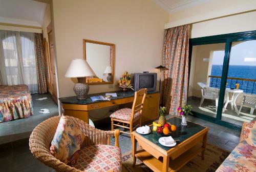 a hotel room with a desk and a room at Island View Resort in Sharm El Sheikh