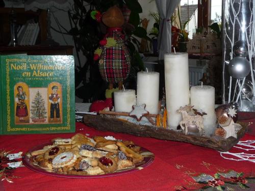 a table topped with a plate of food and candles at Bim Cathele in Burbach