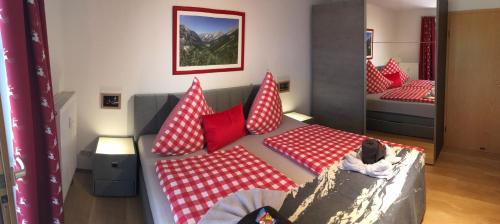 a room with a couch with red and white pillows at ALPENFREUND in Mittenwald