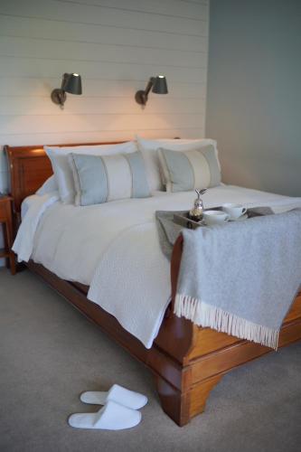 a bedroom with a large bed with white pillows at Pier House in Kinsale