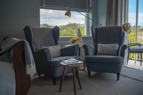 a living room with two chairs and a table at Pier House in Kinsale