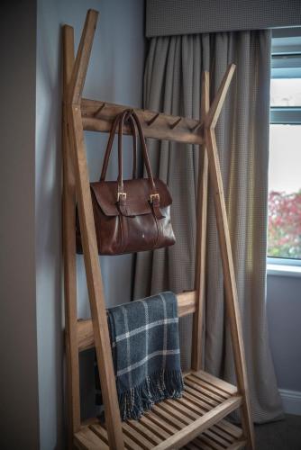 a wooden ladder with a purse on a window at Pier House in Kinsale