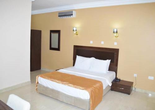a bedroom with a bed in a hotel room at Residency Hotels Ogidi in Ogidi