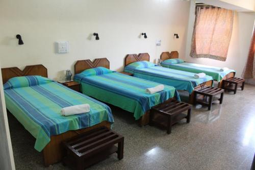 a group of four beds in a room at YWCA International Centre in Mumbai