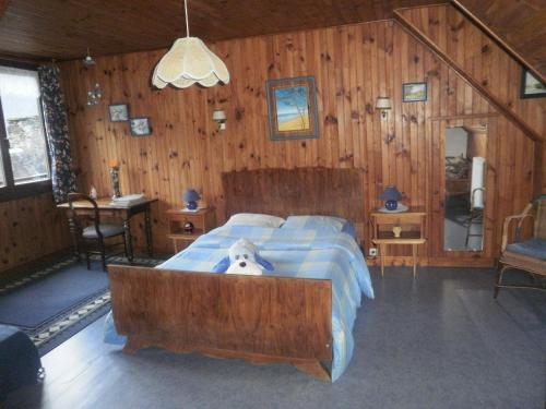 a bedroom with a bed with a stuffed dog in it at grand gite in Cier-de-Luchon