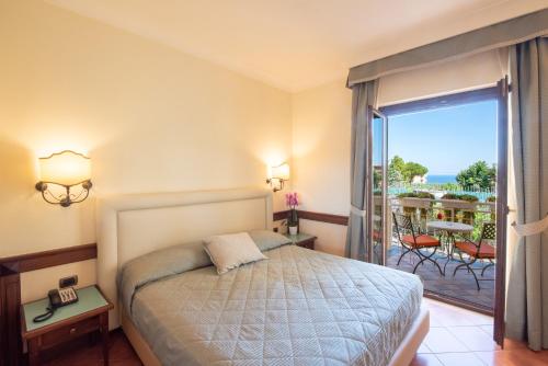 Postel nebo postele na pokoji v ubytování Hotel Michelangelo