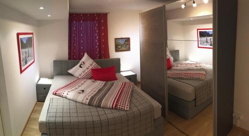 a small room with two beds and a mirror at ALPENFREUND in Mittenwald