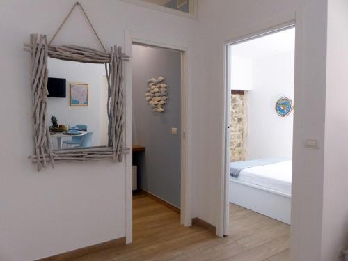 a bedroom with a mirror and a bed at Nesh House in Siracusa