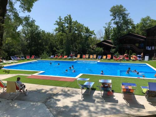 a large swimming pool with people swimming in it at Гостиничный комплекс "Виктория" in Inal