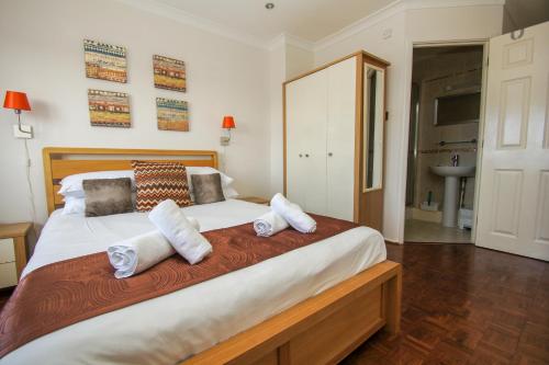 a bedroom with a large white bed with towels on it at Britannia Harbour View - Parking - by Brighton Holiday Lets in Brighton & Hove