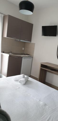 a room with a bed with a white towel on it at Chriselia 2 in Nea Roda