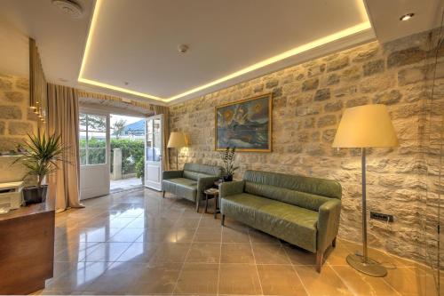 a living room with a couch and a table at Heritage Hotel Leon Coronato in Perast