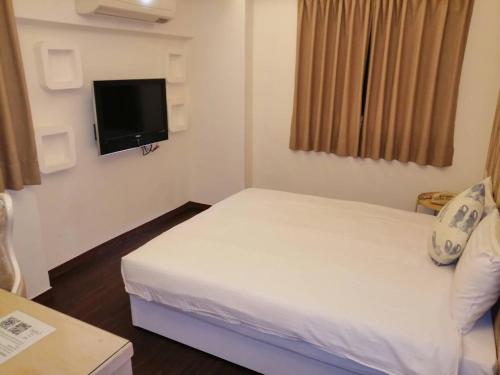TV a/nebo společenská místnost v ubytování Newrise Hotel