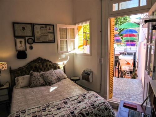 a bedroom with a bed and a view of a patio at Andiamo Guest House in Buenos Aires